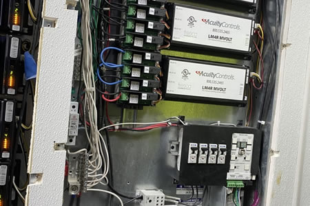 Licensed electrician inspecting a residential electrical panel in Miami, FL