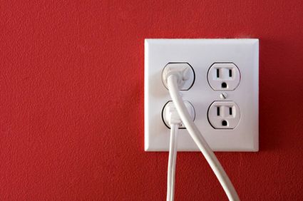 electric outlet on a red painted wall